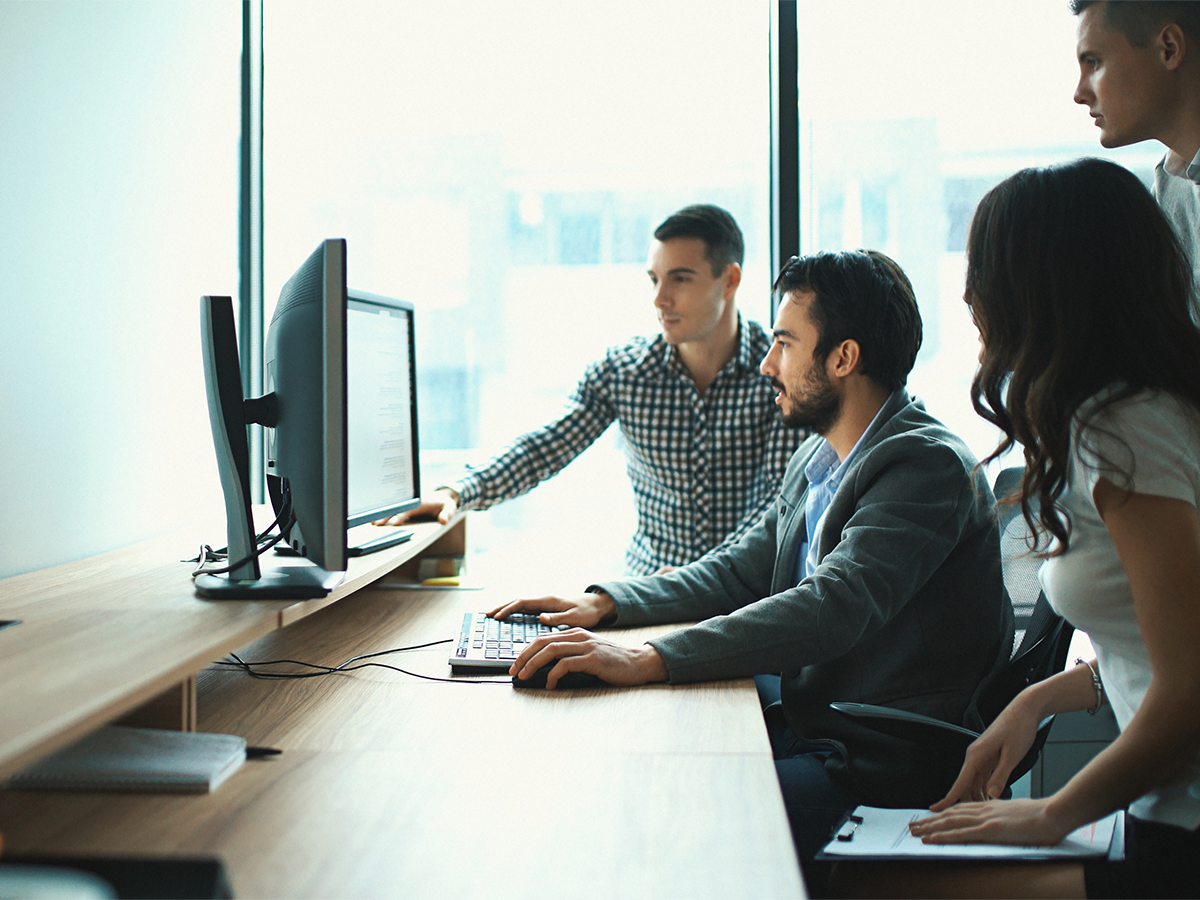 People looking at a monitor together