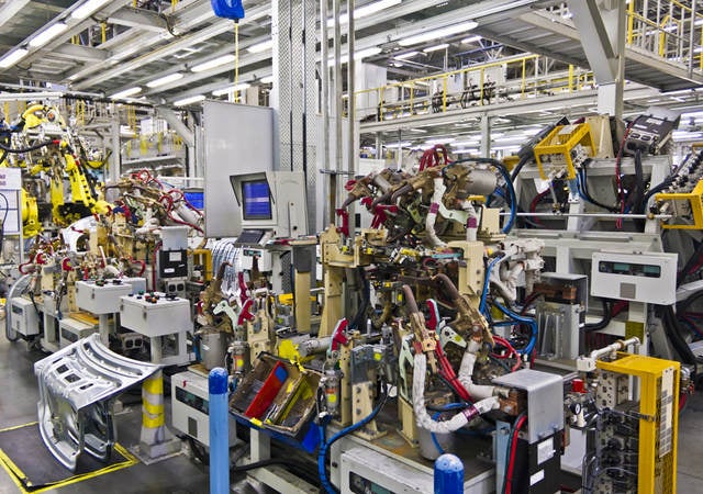 Robotic machines in a factory setting. 