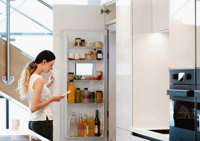 Woman looking into her fridge