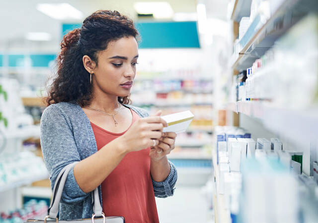 Shopper reading the ingredients on a product 