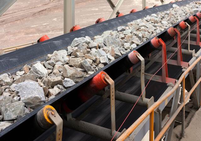Raw material on conveyor belt before being crushed at copper mine in northern Chile.