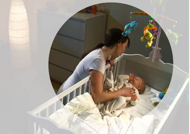 A parent putting a child to nap in a crib